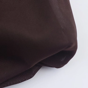 Macro shot of dark brown sheer mesh fabric texture on the casual fashion dress