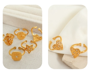 Detailed close-up of gold-plated geometric rings with vintage relief and crystal inlay