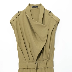 Detail view of khaki green sleeveless jumpsuit with shoulder pads and waist belt details