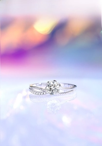 Macro detail of six-prong moissanite ring with twisted pave band and mirror reflection