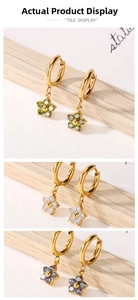 Detailed macro view of three floral zircon earrings in green white and aurora colors