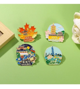 Set of four Nanjing landmark enamel pins including Jiming Temple in a gift display