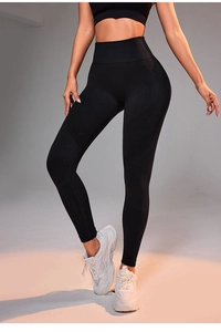 Detail of black high waist yoga pants showing seamless ribbing and breathable mesh textures
