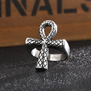 Macro detail of vintage silver Ankh cross ring with textured snakeskin pattern