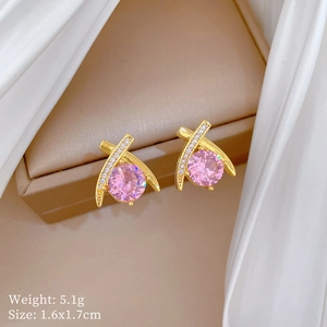 Macro view of gold studs with pink stones weighing 5.1g and sized 1.6x1.7cm
