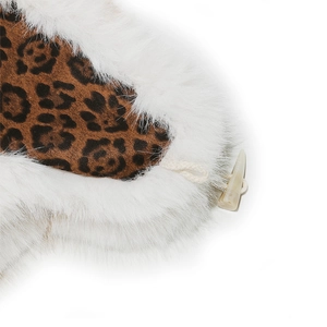 Detail of leopard print lining with white faux fur and a beige toggle button closure