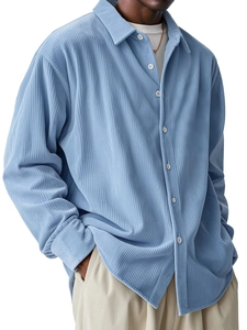 Detail of light blue corduroy shirt for men featuring vertical texture and classic collar
