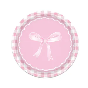 Close-up of pink bow disposable paper plate with gingham pattern and scalloped edges