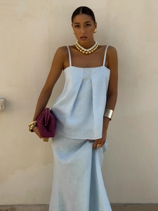 Detail of light blue linen-textured two-piece set featuring thin straps and pleated top