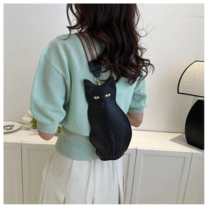 Detail of cute black cat crossbody bag with purple embroidery and plaid strap