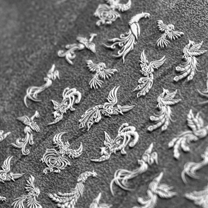Macro view of 5D embossed nail stickers featuring intricate white phoenix feather designs