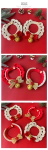 Detailed tile display of Christmas pet knit scarves with bells and gold star accents