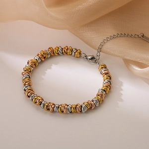 Three-tone mixed metal chain bracelet with gold, silver, and rose gold beads