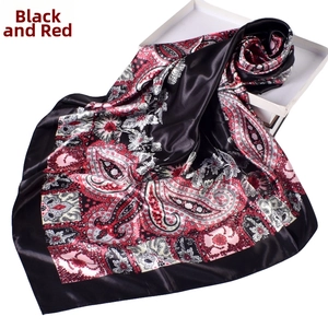 Macro detail of red and black paisley pattern on silk-satin square scarf texture