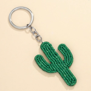 Macro detail of handmade green beaded cactus charm with silver metal keyring