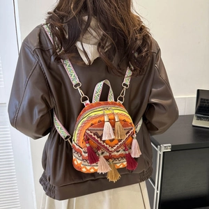 Ethnic style woven backpack with colorful geometric patterns and decorative tassels