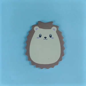 Close-up of cute brown hedgehog-shaped sticky notes on a clean light blue background