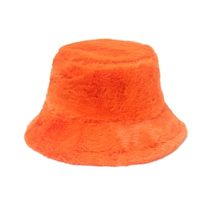 Close-up of fluffy orange faux fur winter bucket hat with soft plush texture and warmth