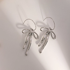 Polished silver stainless steel bow pendant earrings with sleek long hook design