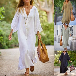 Detail of the V-neck button-down cotton linen dress with lantern sleeves and textured fabric