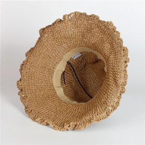 Wide brim khaki straw sun hat with frayed edges and inner adjustable chin strap