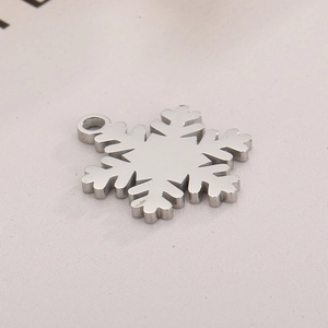 Close-up of polished silver snowflake pendant with a classic hexagonal cutout design