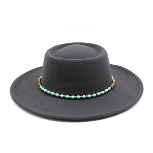 Close-up of charcoal felt boater hat with turquoise beaded chain and vintage accents