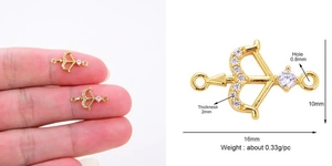 Detailed size specifications for a gold-plated bow and arrow jewelry connector with zircons