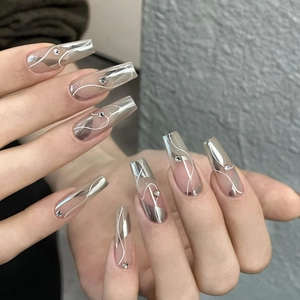 Long coffin press-on nails with silver chrome metallic swirls and rhinestone accents