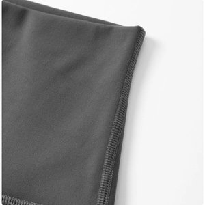 Macro shot of durable flatlock stitching on dark gray high-elastic yoga pants fabric