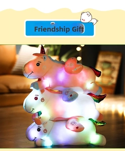 Detailed view of three stacked glowing unicorn plush toys in a warm indoor setting