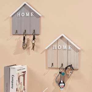Nordic wooden house-shaped key holder with three metal hooks and HOME lettering