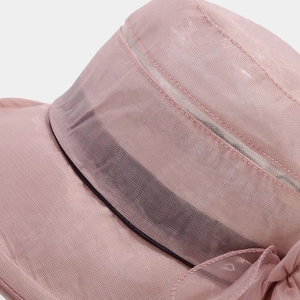 Detail of pink sun hat featuring breathable mesh panel and elegant silk bow decoration