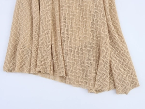 Detailed macro view of the beige mesh knit fabric with openwork geometric patterns
