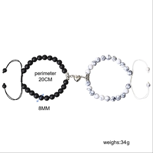 Detail of 8mm matte black and white marble beaded couple bracelets with heart magnetic clasp