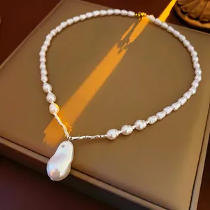 Irregular baroque pearl drop necklace with vintage metal clasp on brown jewelry box