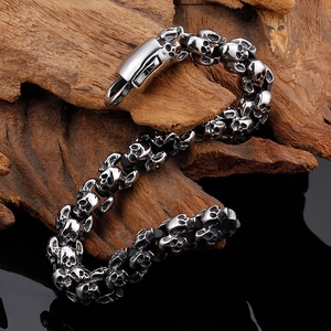 Macro view of a retro silver skull bracelet on aged wood with a mirror reflection