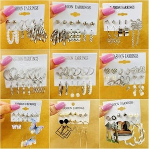 Macro view of assorted hip-hop style earrings set featuring metal and pearl details