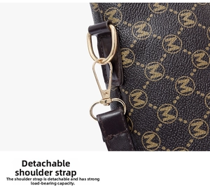 Detail of detachable shoulder strap with golden metal clasp on a monogram tote bag