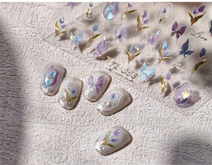 Detail of laser butterfly and tulip nail stickers with iridescent finish on white tips