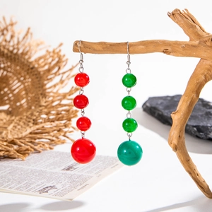 Macro shot of colorful beaded Christmas earrings with red and green gradient beads