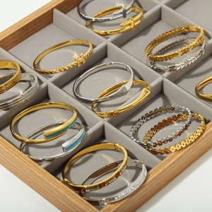 Collection of gold and silver plated stainless steel bangles with cubic zirconia and enamel