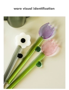 Detail of colorful flower glass stir sticks with tulip and daisy shapes for coffee