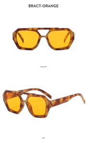 Detail view of retro tortoise shell aviator sunglasses with orange tinted lenses