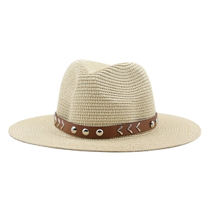 Women's beige straw sun hat with brown leather rivet band for outdoor beach wear