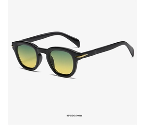Detail view of black retro sunglasses featuring gold arrow hardware and yellow gradient lenses