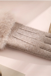 Detail of tan thermal winter gloves showing faux fur cuffs and decorative stitching