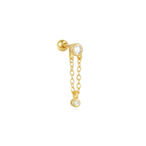Macro view of gold chain earring with sparkling zircon stones and ball screw back