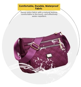 Close-up of waterproof purple quilted nylon fabric with splashing water droplets detail