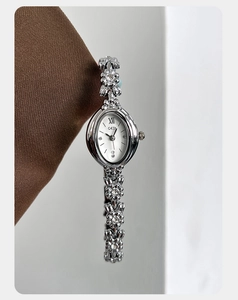 Detail of GEDI oval watch featuring a flower-shaped bracelet with rhinestone accents